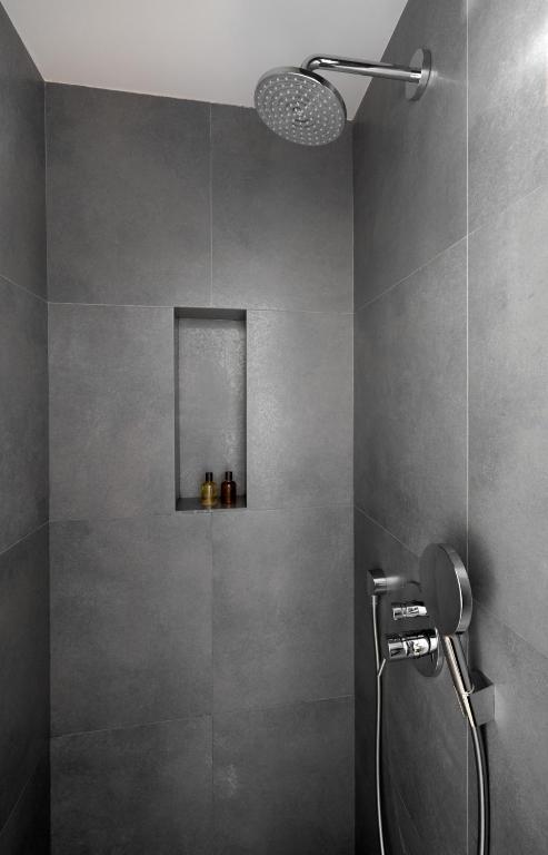a bathroom with a shower with a shower head at Le Pre de la Mer in Saint-Tropez