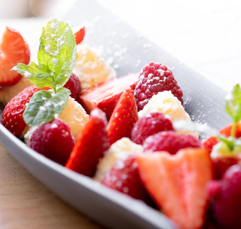 a bowl of fruit with a green leaf on top at Le Pre de la Mer in Saint-Tropez