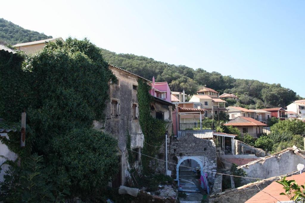 a group of houses on a hill with a town at Nafsika in Ágios Matthaíos