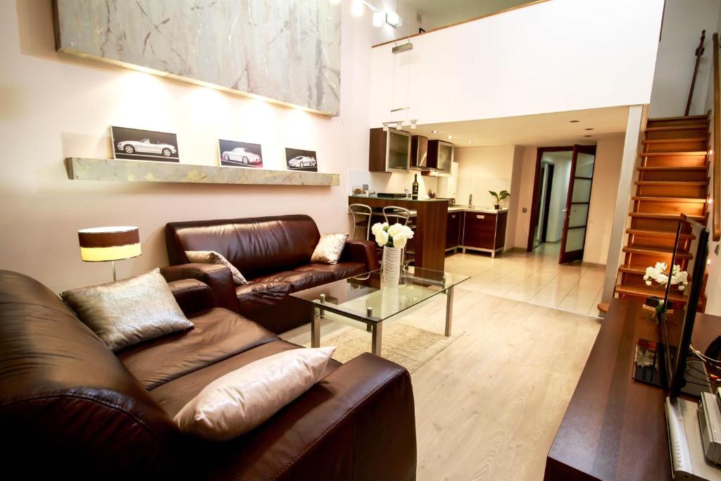 a living room with a leather couch and a glass table at Apartment Grecheskie in Odesa