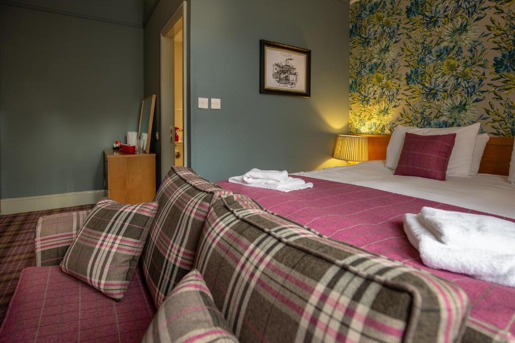 a bedroom with a bed and a couch in it at Woodthorpe Hotel in Manchester
