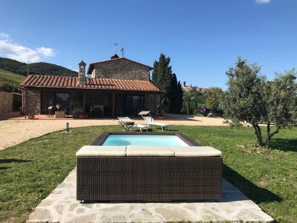 a swimming pool in the yard of a house at Il Podere Bellavista in Montecatini Val di Cecina