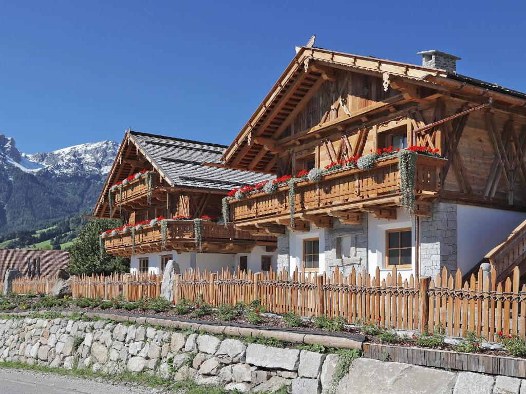 a wooden house with a fence in front of it at Chalet Piz da Peres in Valdaora