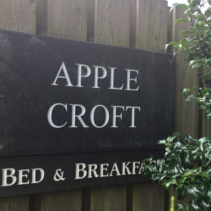 a sign for an apple croft on a wooden fence at Applecroft Bed and Breakfast in St Austell