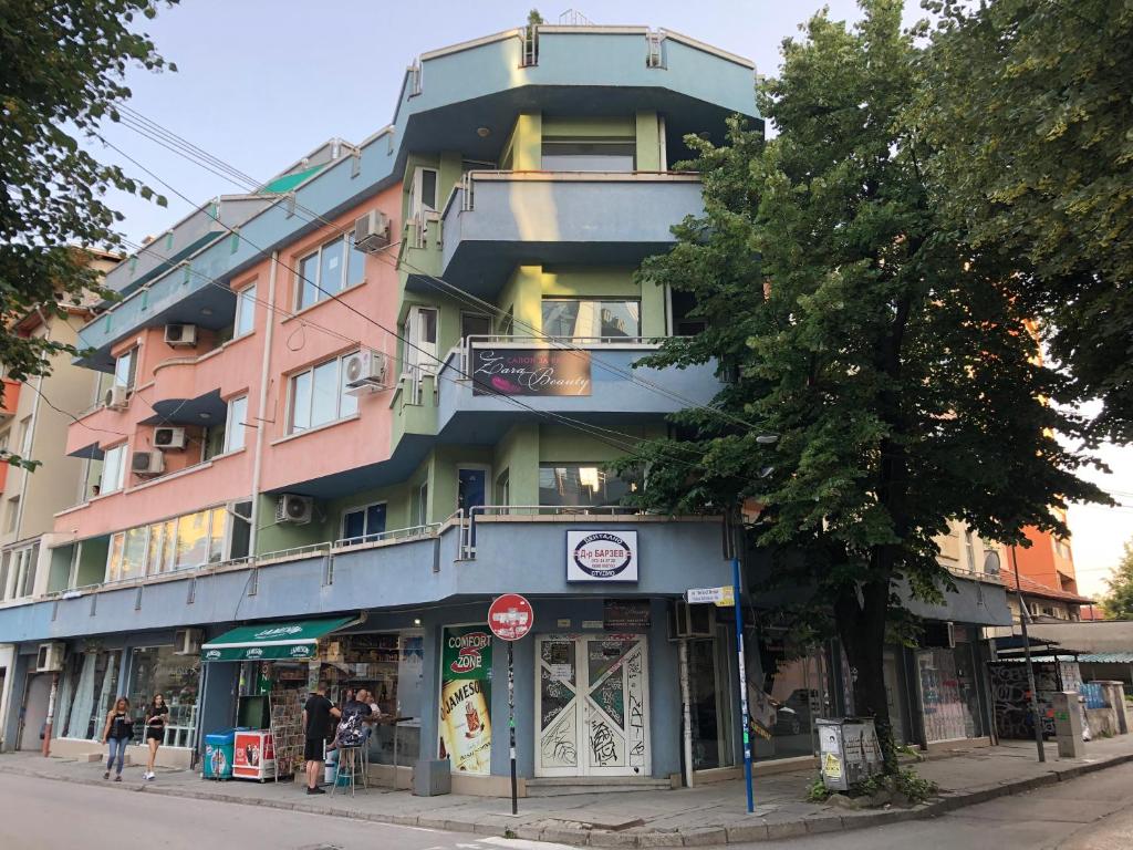 a tall building on a city street with a stop sign at Apartment Lili in Blagoevgrad