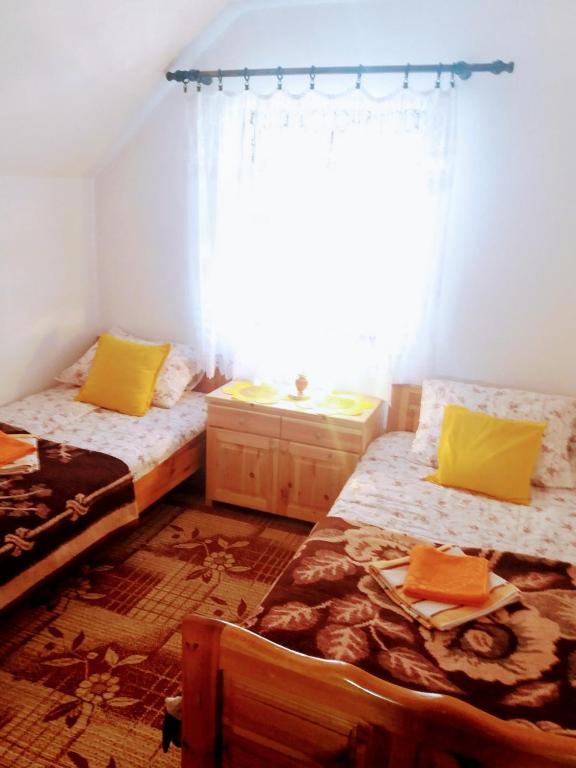 Postel nebo postele na pokoji v ubytování Apartments And Rooms Gold