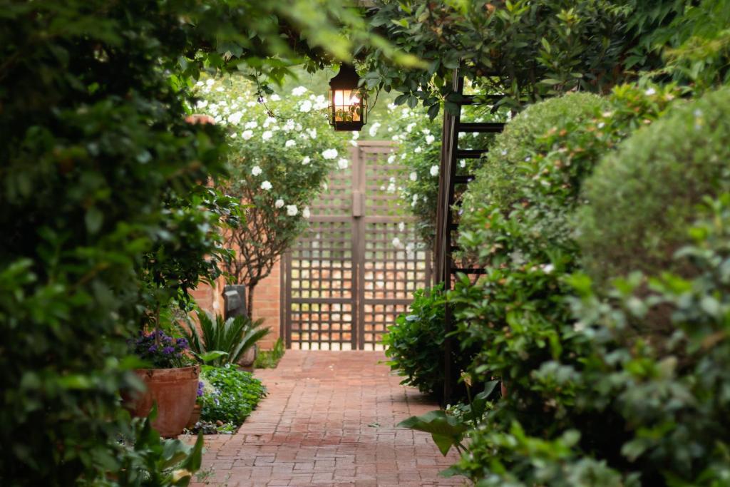 a gate in a garden with a brick walkway at Twin Rivers Bed and Breakfast in Irene