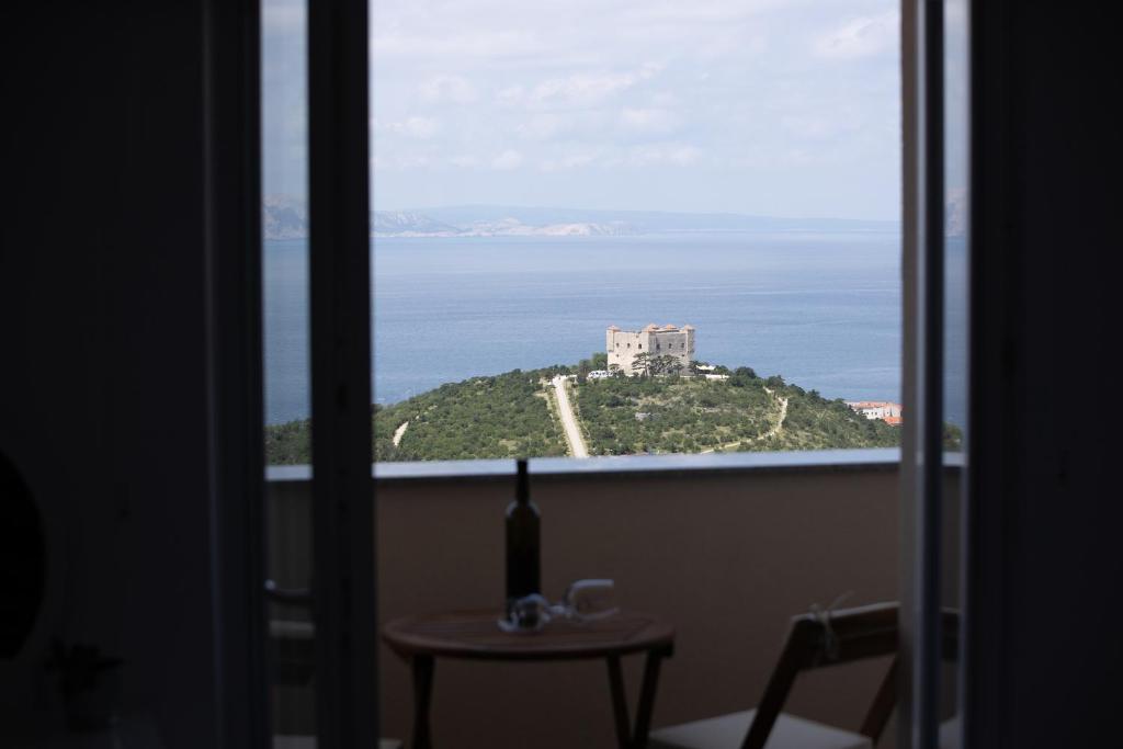 a view of a castle from a room with a window at VisumApartments in Senj