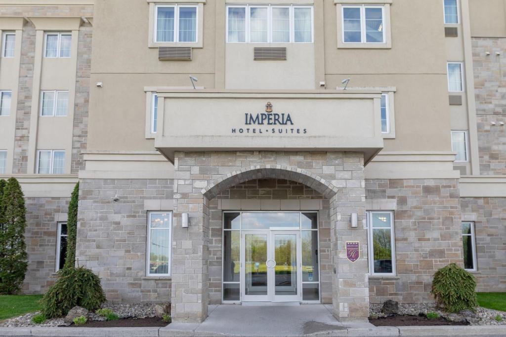 a building with an entrance to a hotel at Imperia Hotel & Suites Saint-Eustache in Saint-Eustache