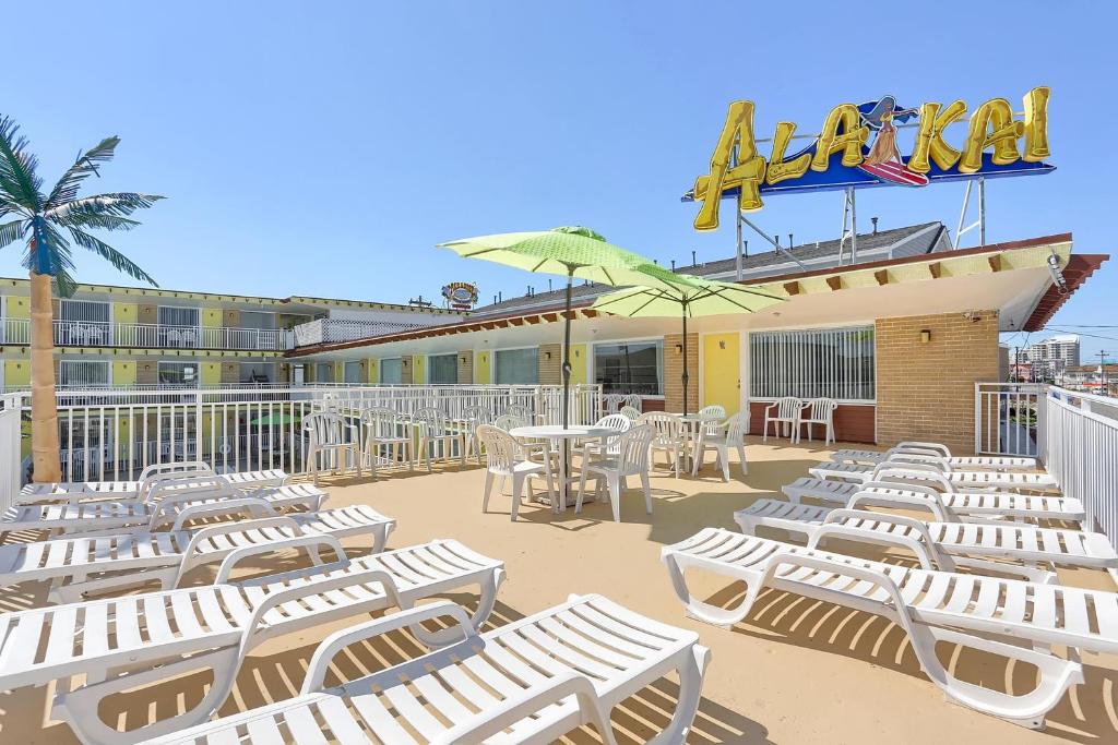 a group of white chairs and tables on a patio at Ala Kai Resort Motel in Wildwood Crest