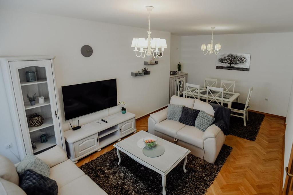 un soggiorno con divano e tavolo di Apartman M5 a Ðakovo