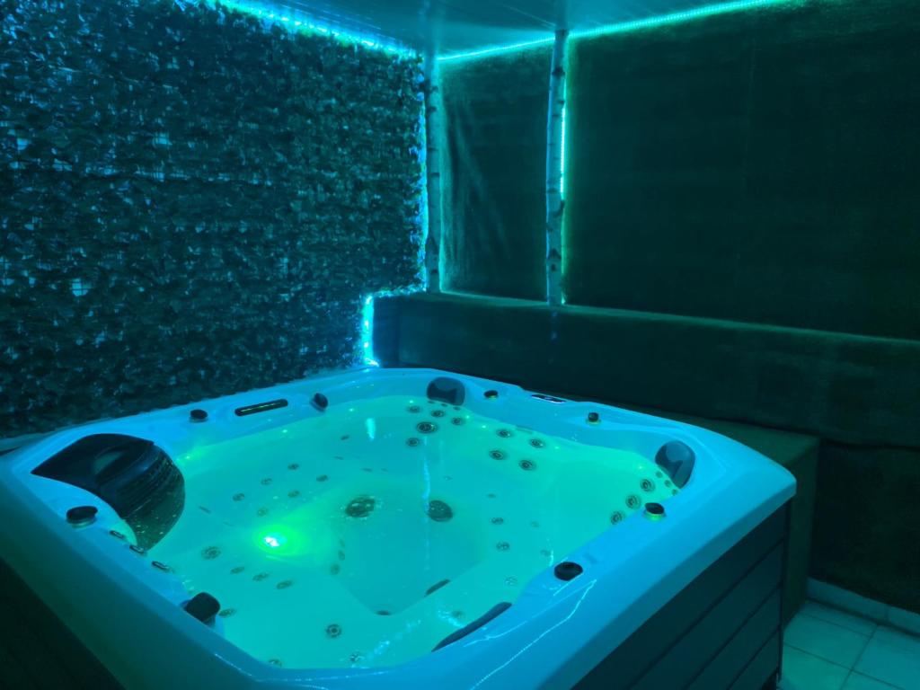 een badkamer met een bad met blauwe verlichting bij Apartment Relax whit big terrace 170m2 Near the Beach in Split