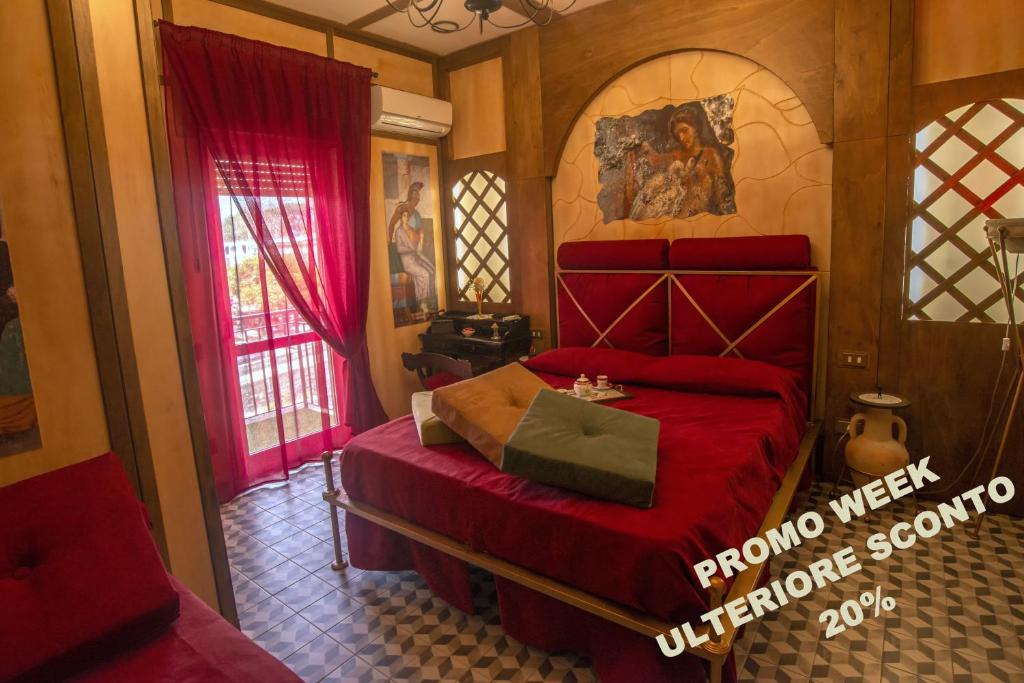 a bedroom with a red bed and a window at Nives Bed & Breakfast in Pompei