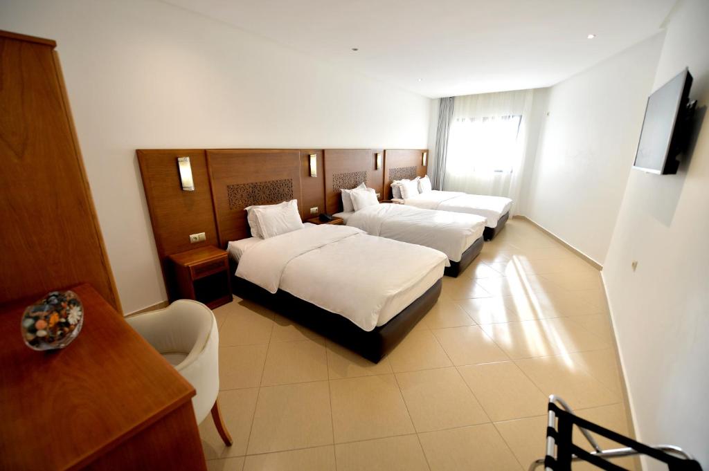 Postel nebo postele na pokoji v ubytování Hotel El Djenina