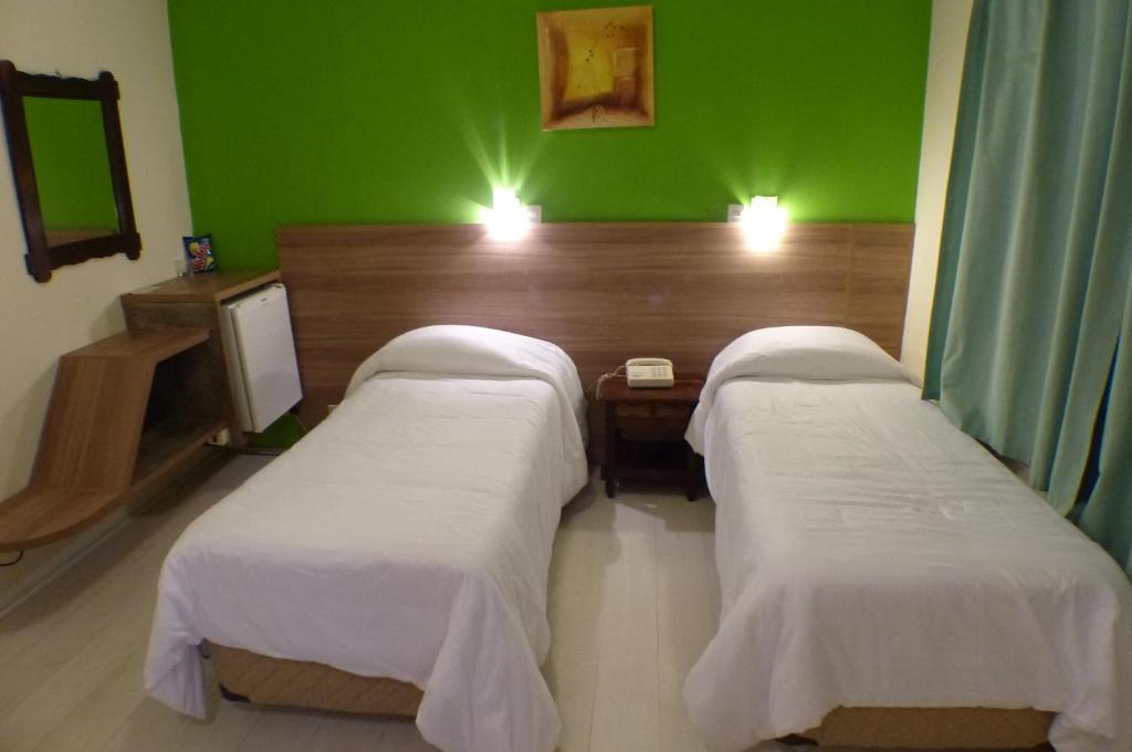 Uma cama ou camas num quarto em Hotel JB