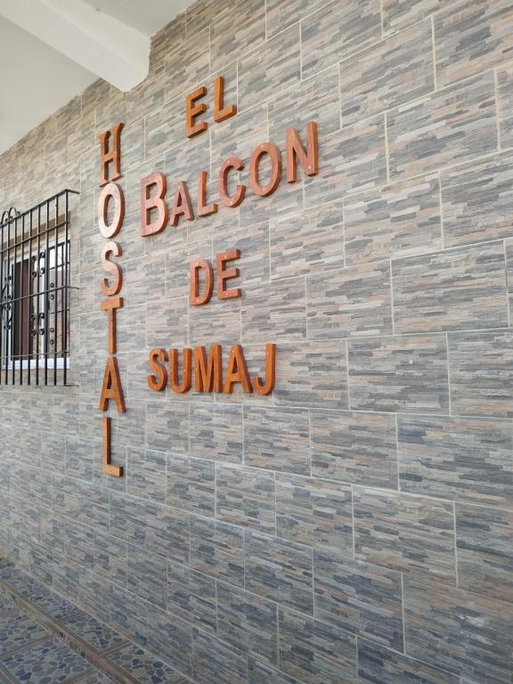 a brick wall with a sign that reads a restaurant be a sandwich at El Balcón de Sumaj in Maimará