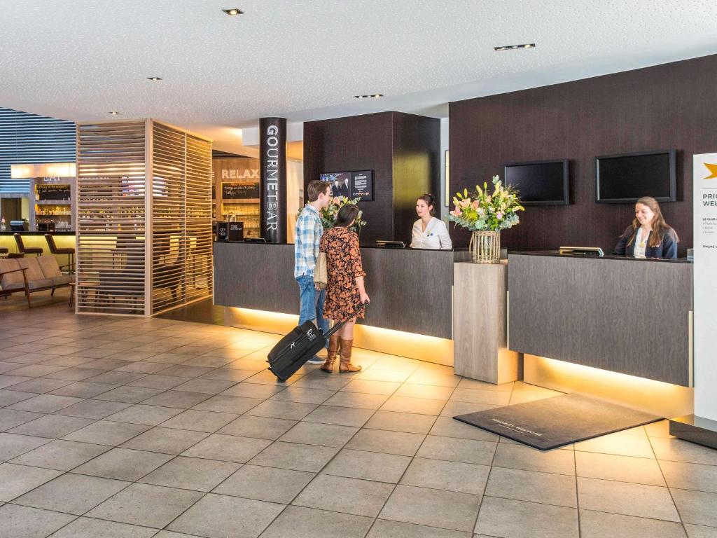 TV a/nebo společenská místnost v ubytování Novotel Mechelen Centrum