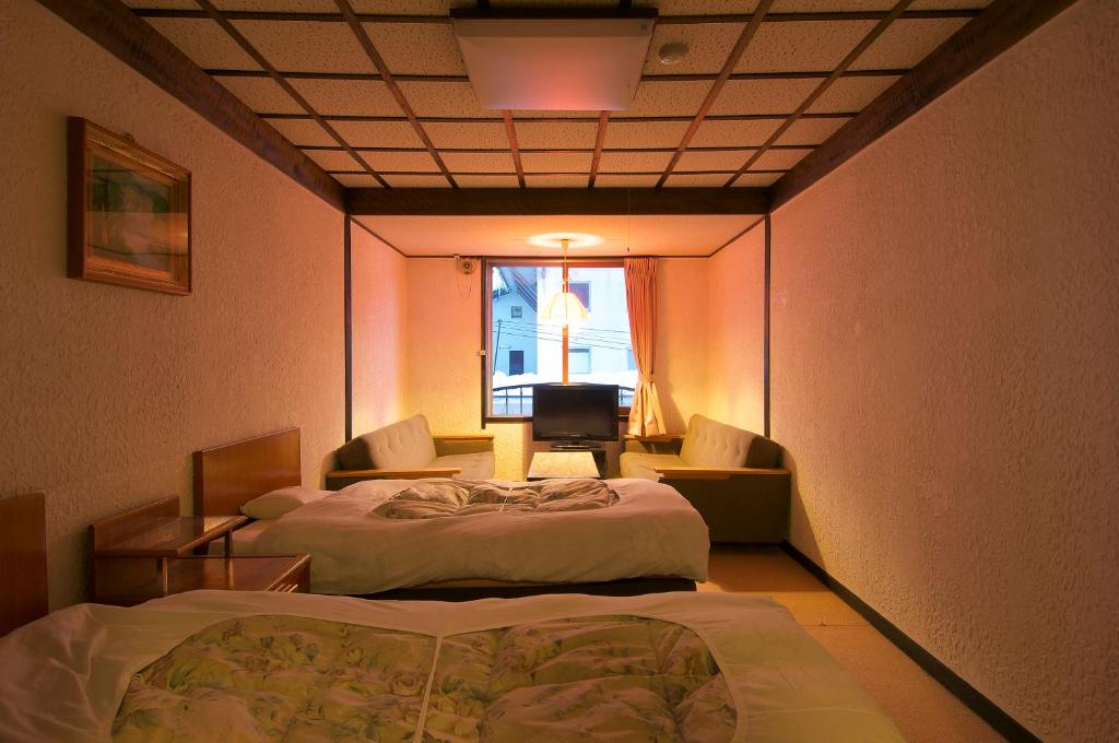 Postel nebo postele na pokoji v ubytování Hotel Sanraku
