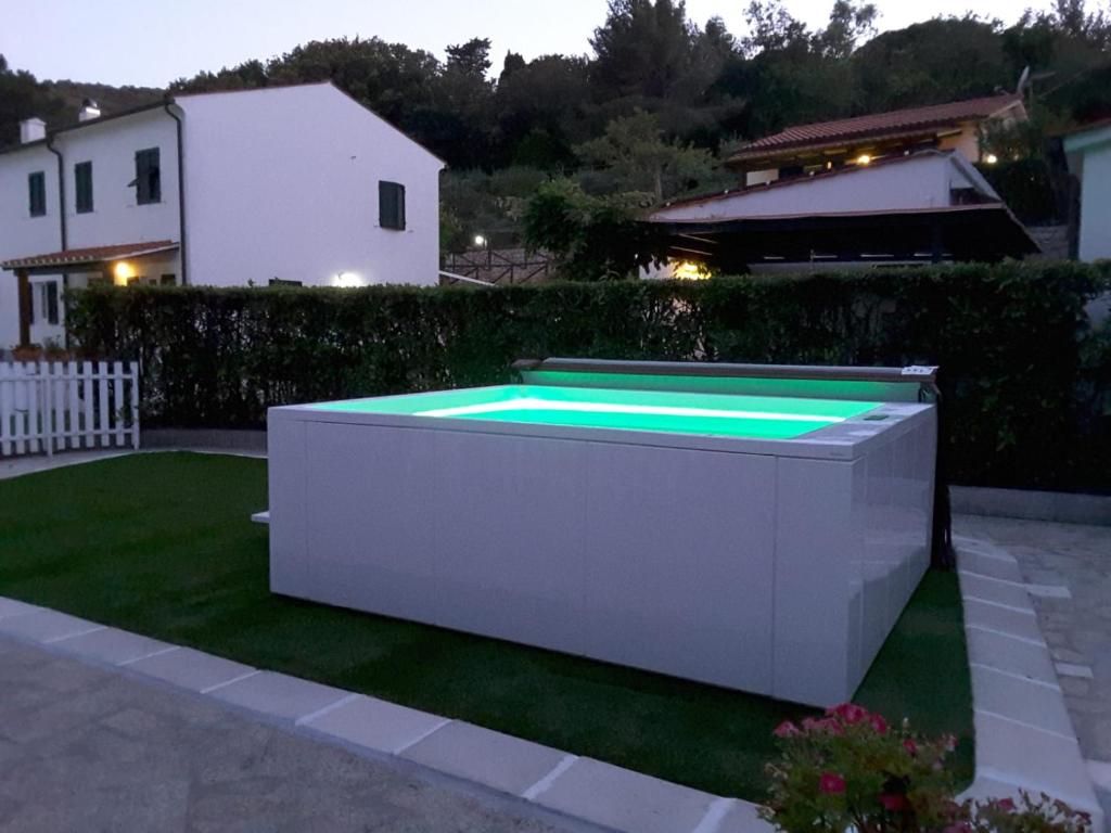 a swimming pool in a garden at night at Marina VIP in Marciana