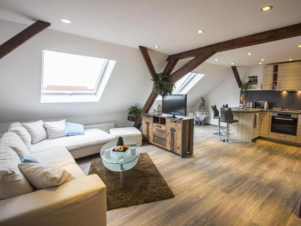 a living room with a white couch and a table at Ferienwohnung Innenstadt in Oberkirch