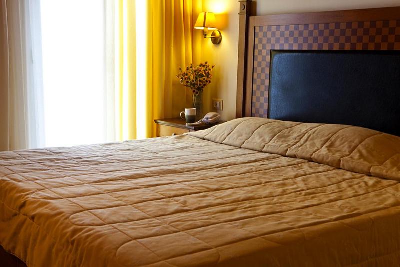 Postel nebo postele na pokoji v ubytování Lassi Hotel