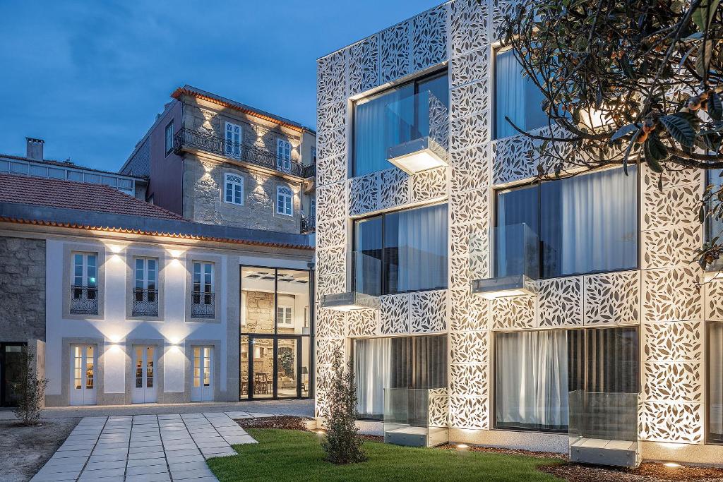 an exterior view of a building with lights on it at Caléway Hotel in Vila Nova de Gaia