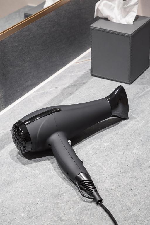 a black iron on the floor next to a box at Copenhagen Admiral Hotel in Copenhagen