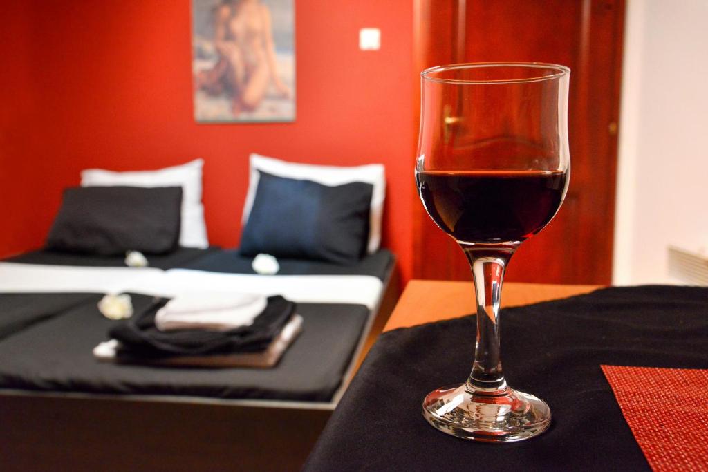 um copo de vinho sentado em cima de uma mesa em Tomas Apartments em Skopje