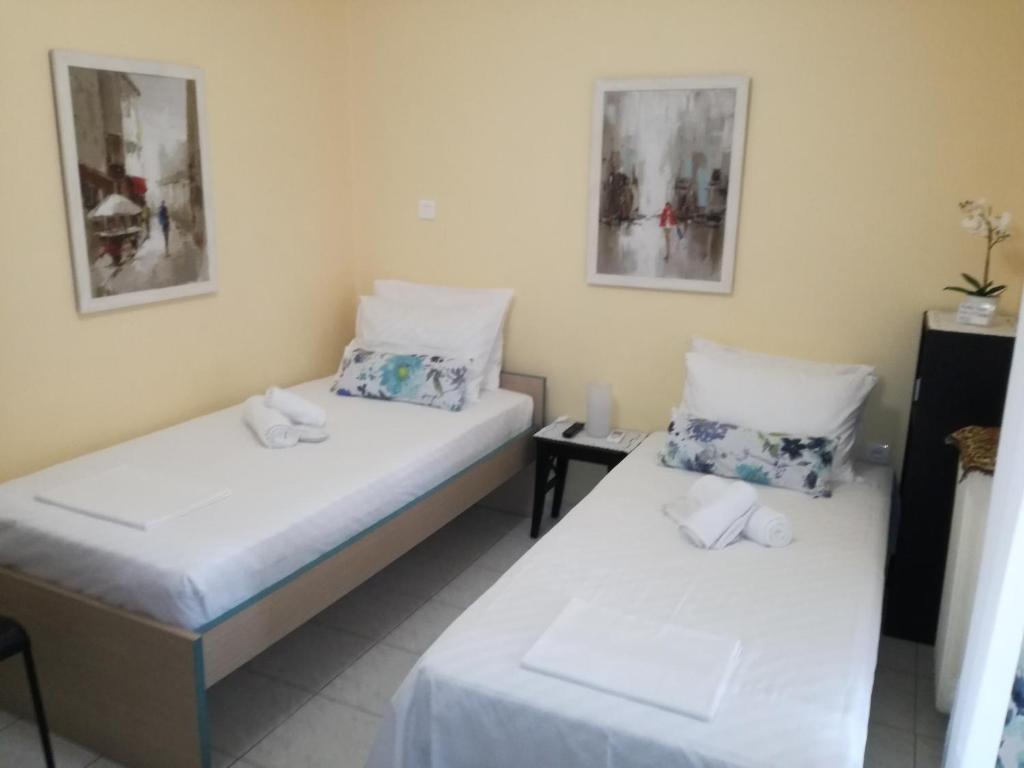 a room with two beds and a table at Apartment studio near Marousi station Athens in Athens