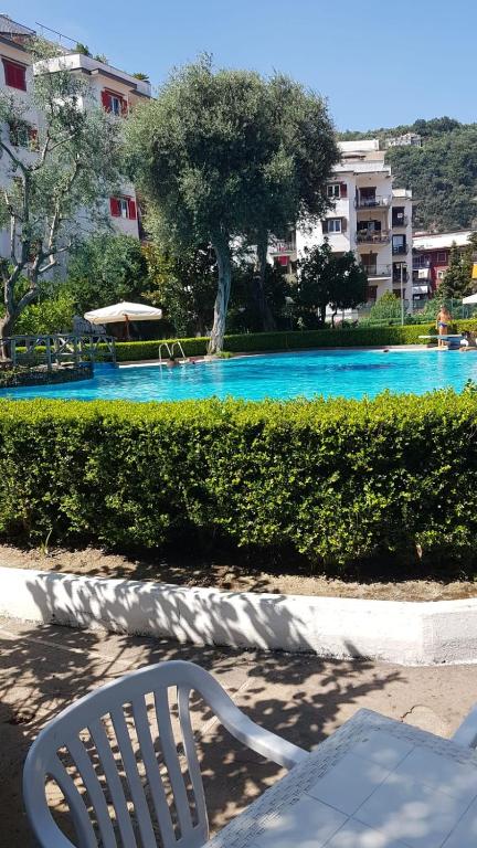 a white chair sitting in front of a swimming pool at BLU SEA SORRENTO in Sorrento