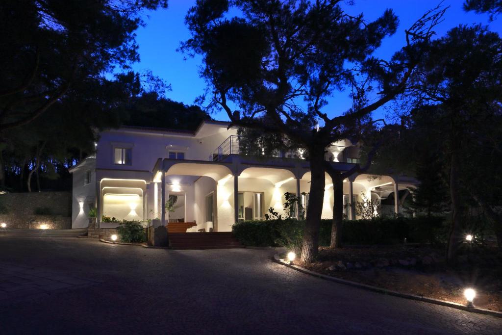 a white house at night with lights on it at Dimora Villa Serena Porto Selvaggio in Santa Caterina di Nardò