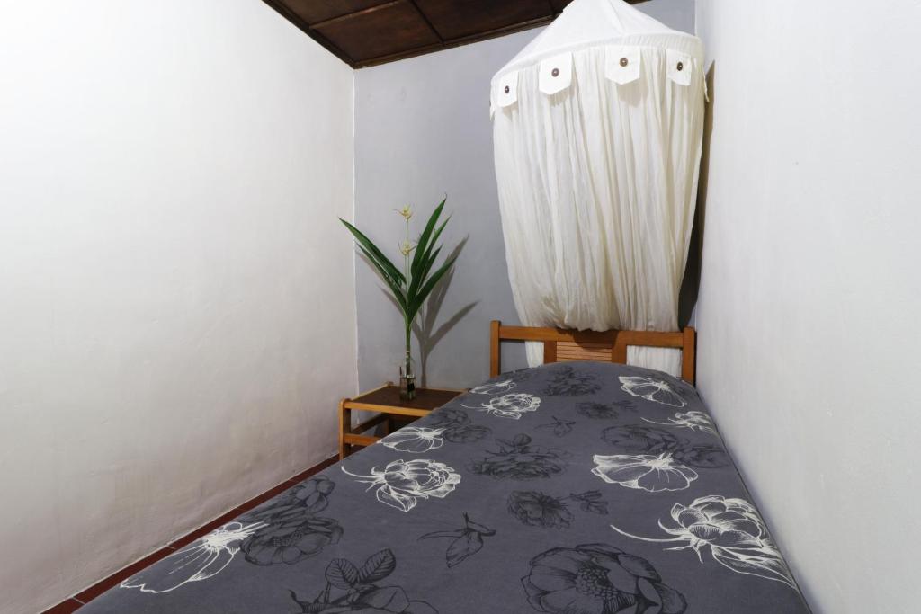 a bedroom with a bed and a curtain at Bagus Bay Homestay in Tuktuk Siadong