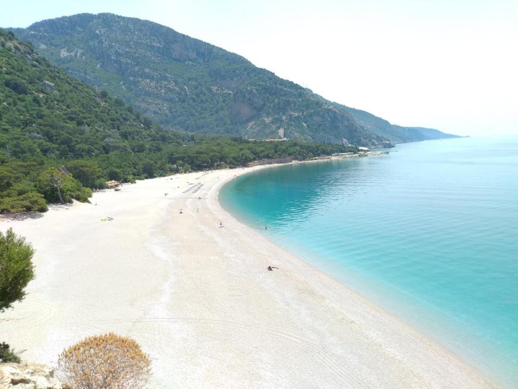 a view of a beach with people in the water at Kidrak Camping NAMASTE in Faralya