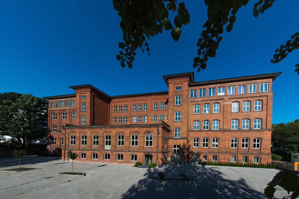 
a large brick building with a clock on the side of it at Volksschule in Hamburg
