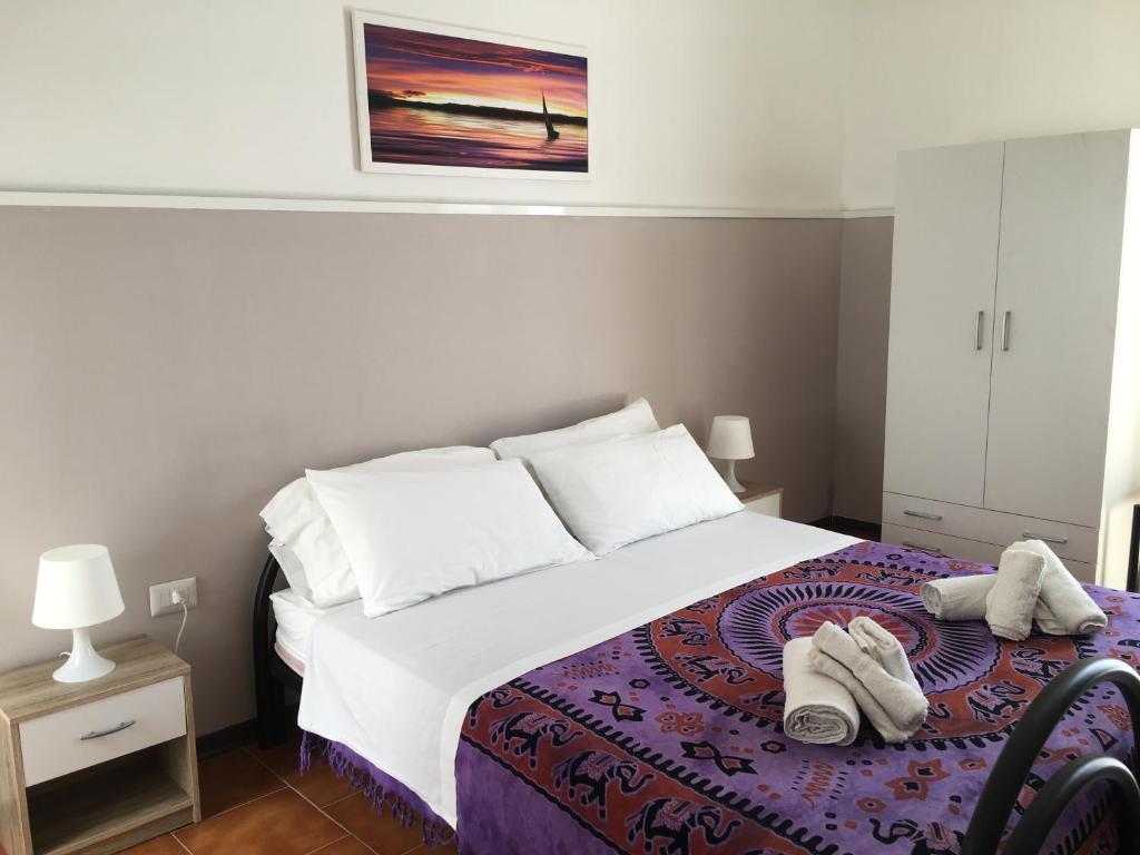 מיטה או מיטות בחדר ב-Cimalù by Lampara