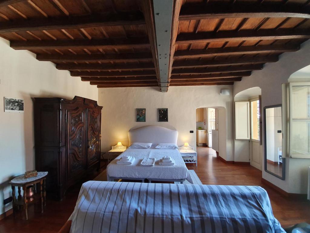 a large bedroom with two beds and wooden ceilings at Palatina apartment in Turin