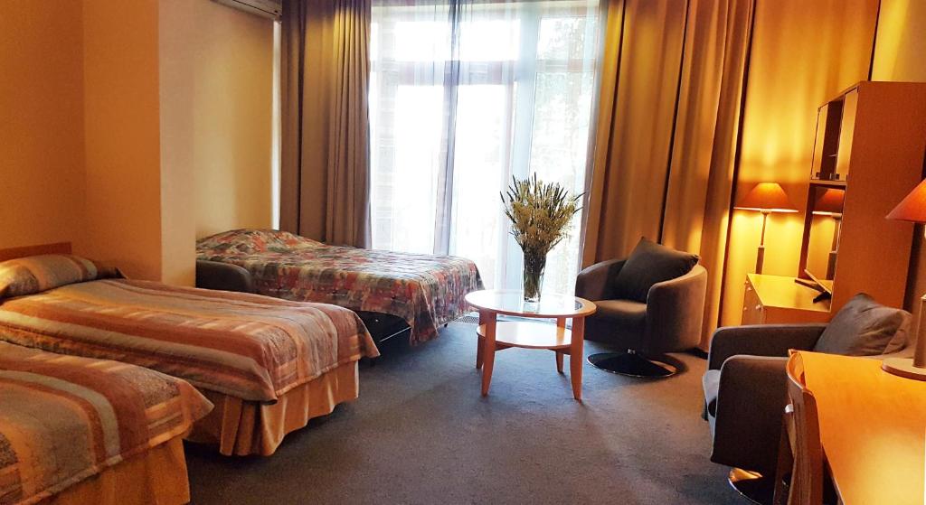 Postel nebo postele na pokoji v ubytování Perkuno Namai Park Hotel