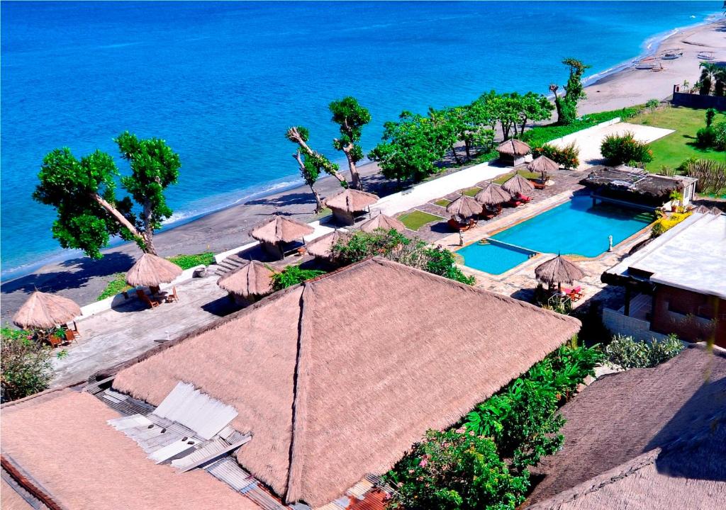 an aerial view of a resort with a swimming pool and the ocean at Pasific Beach Cottages in Senggigi