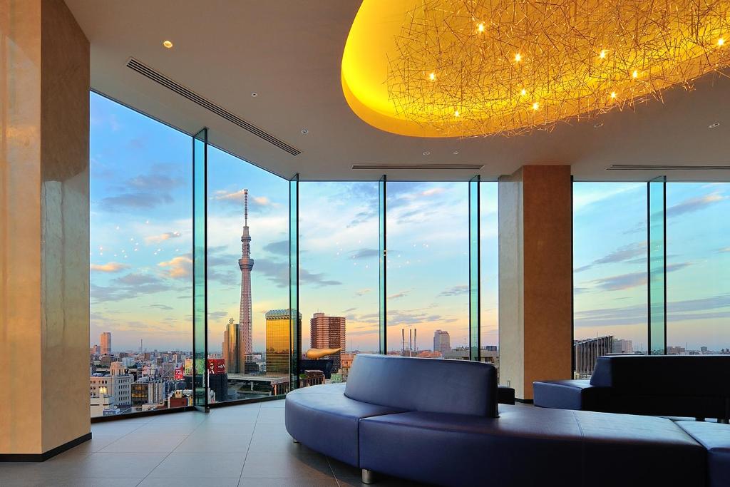 a living room with a view of a city at The Gate Hotel Asakusa Kaminarimon by Hulic in Tokyo