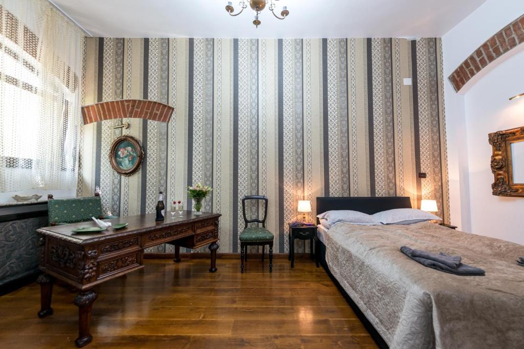 - une chambre avec un lit et un bureau dans l'établissement Casa Miron Unirii 2, à Timişoara