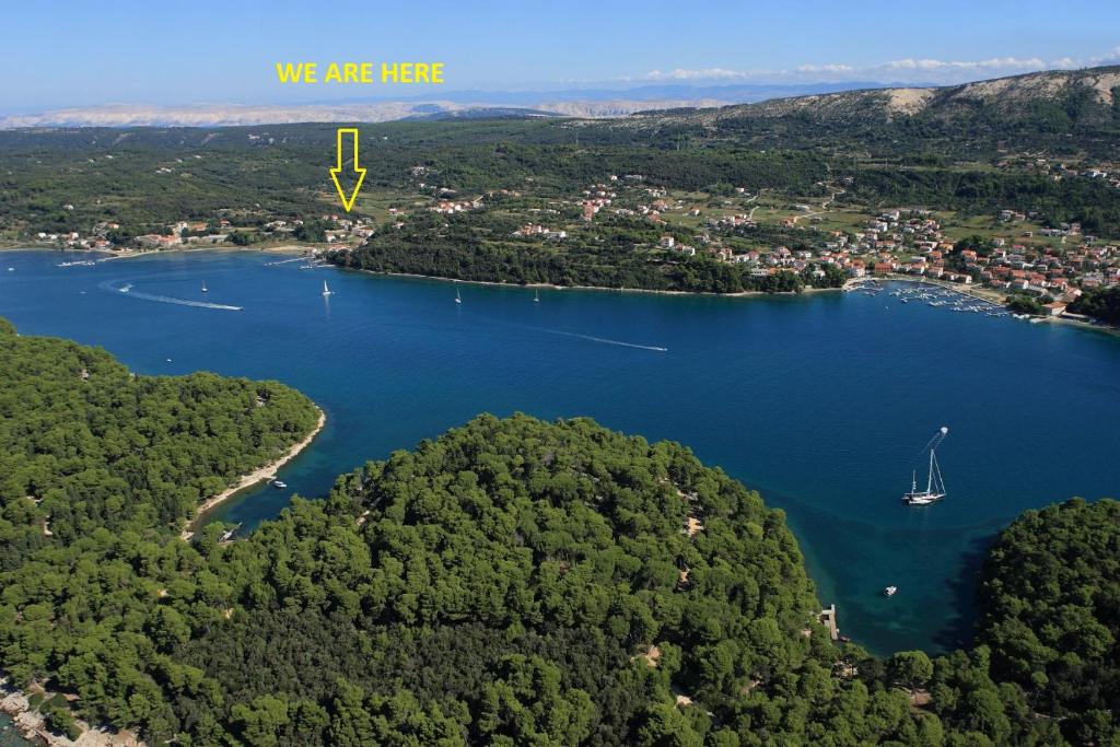 an aerial view of a lake with a boat in it at Lola Apartment in Rab