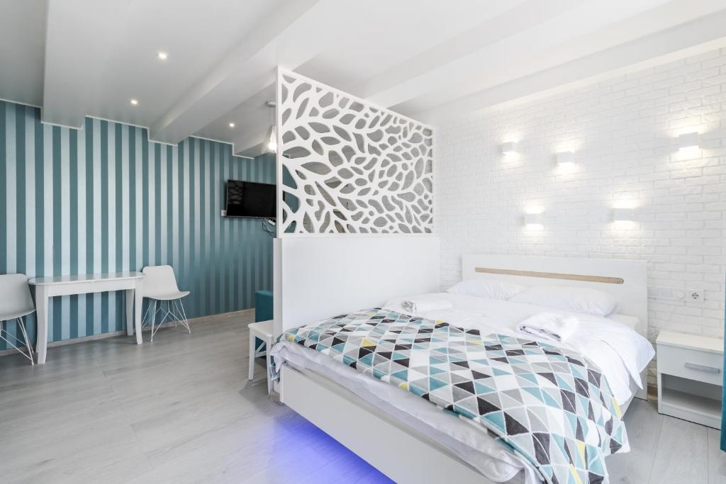 a bedroom with a bed with a geometric headboard at VIP Apartment in Lviv