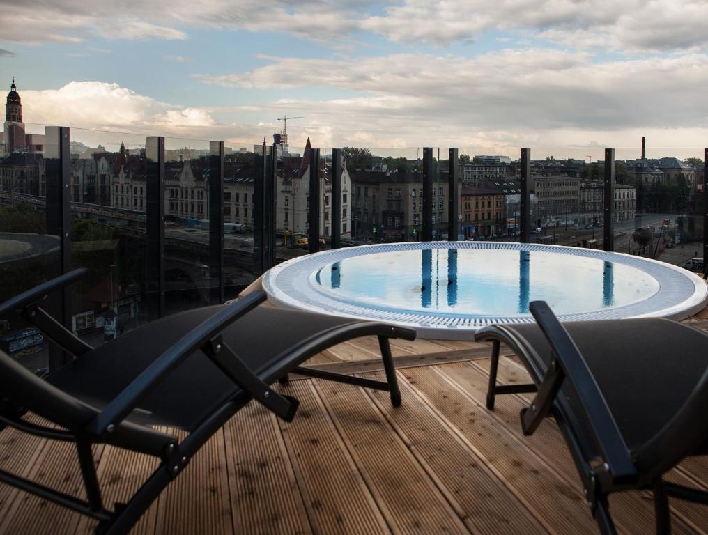 a swimming pool on the roof of a building at The Loft Hotel Adults Only in Kraków