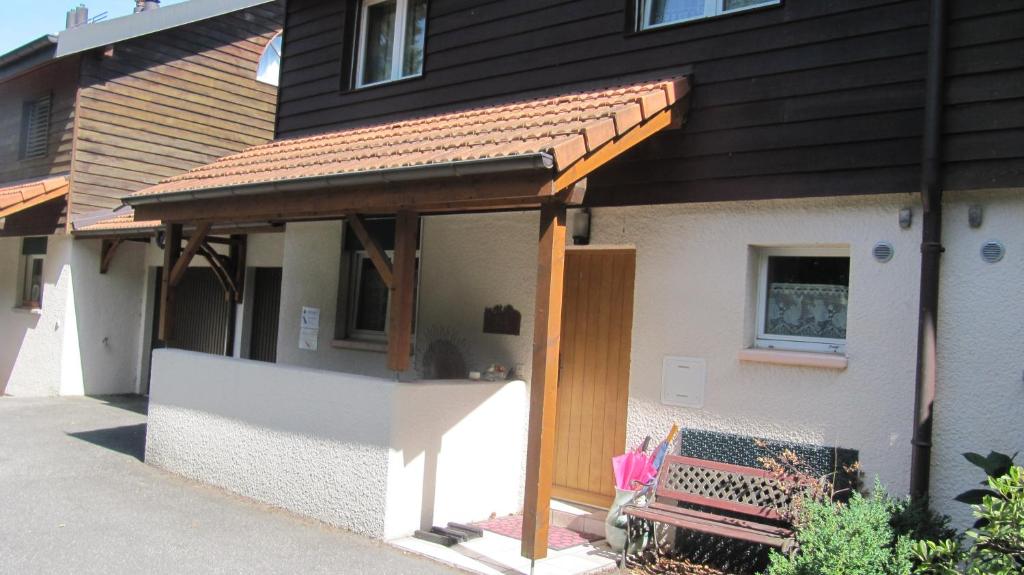 a pavilion on the side of a house with a bench at Home to Rent in Bellevue