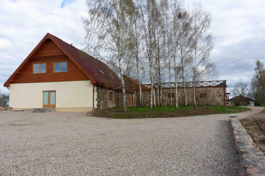 a house with a barn with a silo at Albireo in Talsi