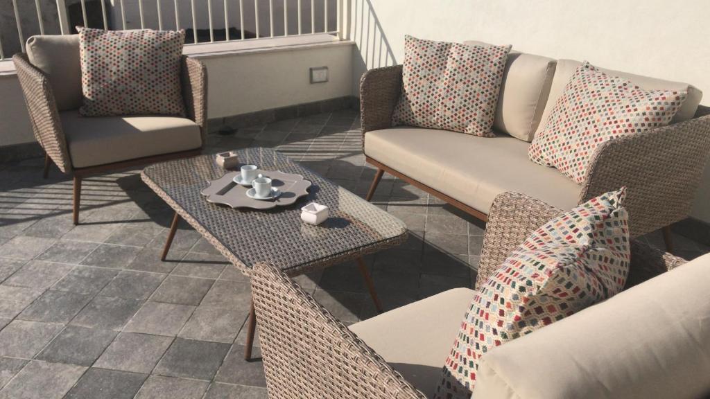 a living room with a couch and chairs and a table at Estlevante B&B in Vieste