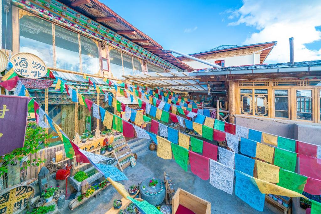 a building with colorful flags on the side of it at Home Away From Home in Shangri-La