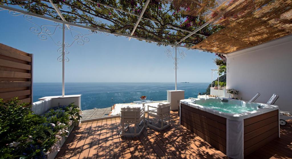 a bathroom with a bath tub on a patio at Hotel Montemare in Positano