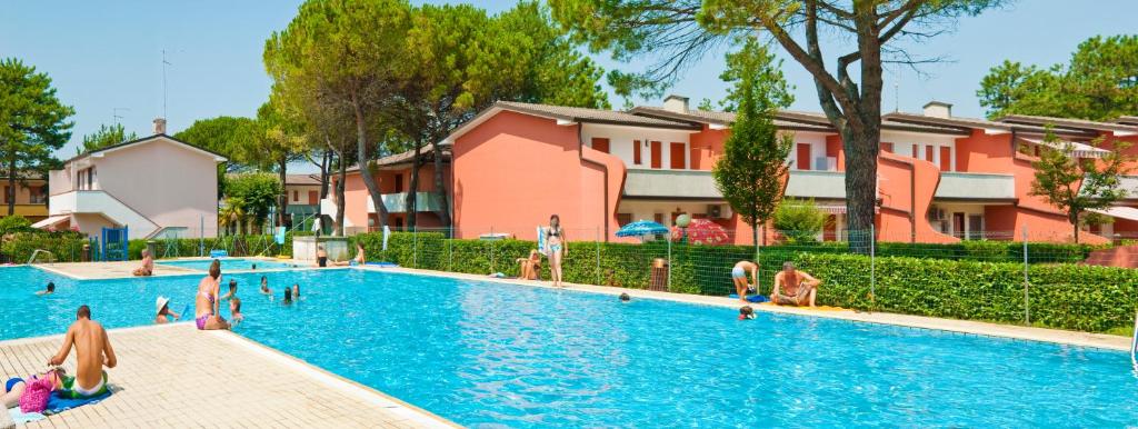 un gruppo di persone in una piscina in un resort di Villaggio Azzurro a Bibione