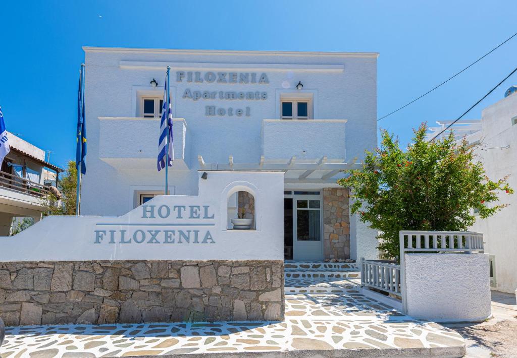 a white building with a sign in front of it at Filoxenia Apartments in Adamas